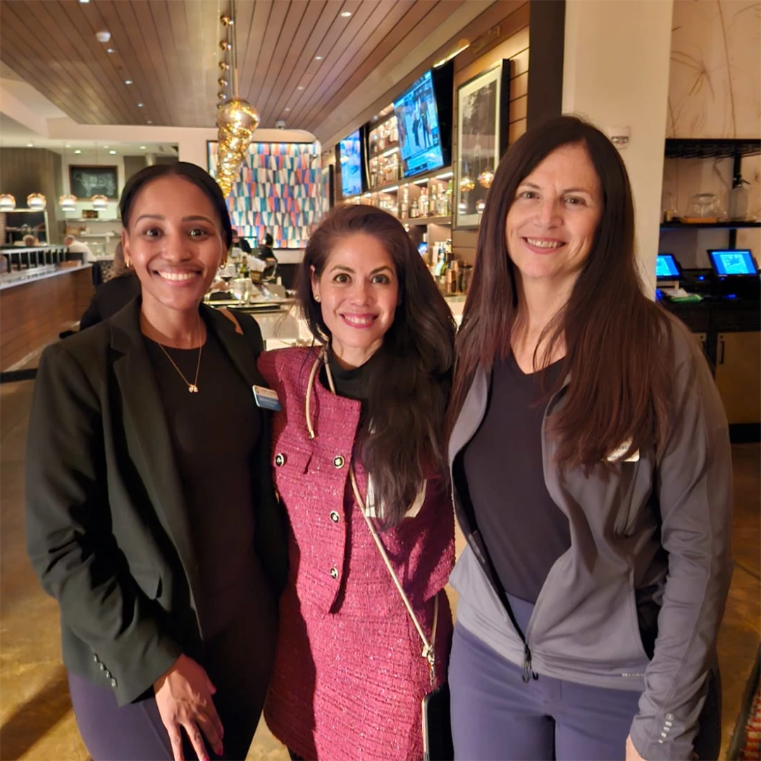 Three friends gathered in a restaurant.